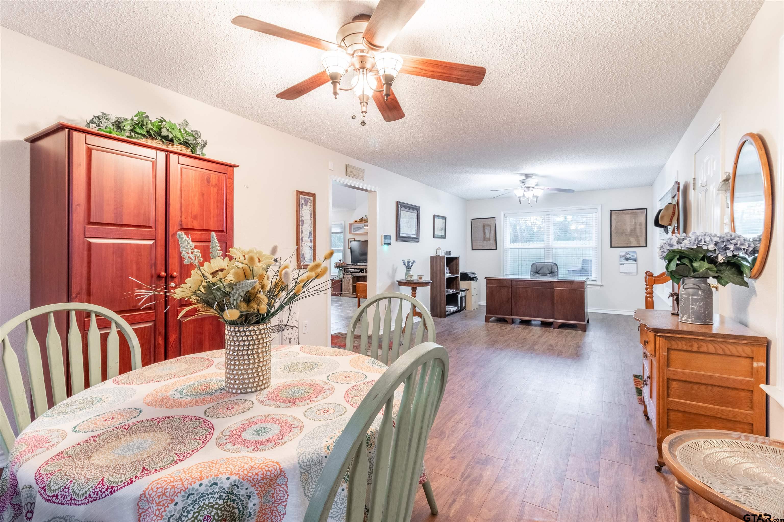 18219 Eastside Road Troup, TX 75789 - Photo 12 of 48 a living room with furniture potted plant and a chandelier