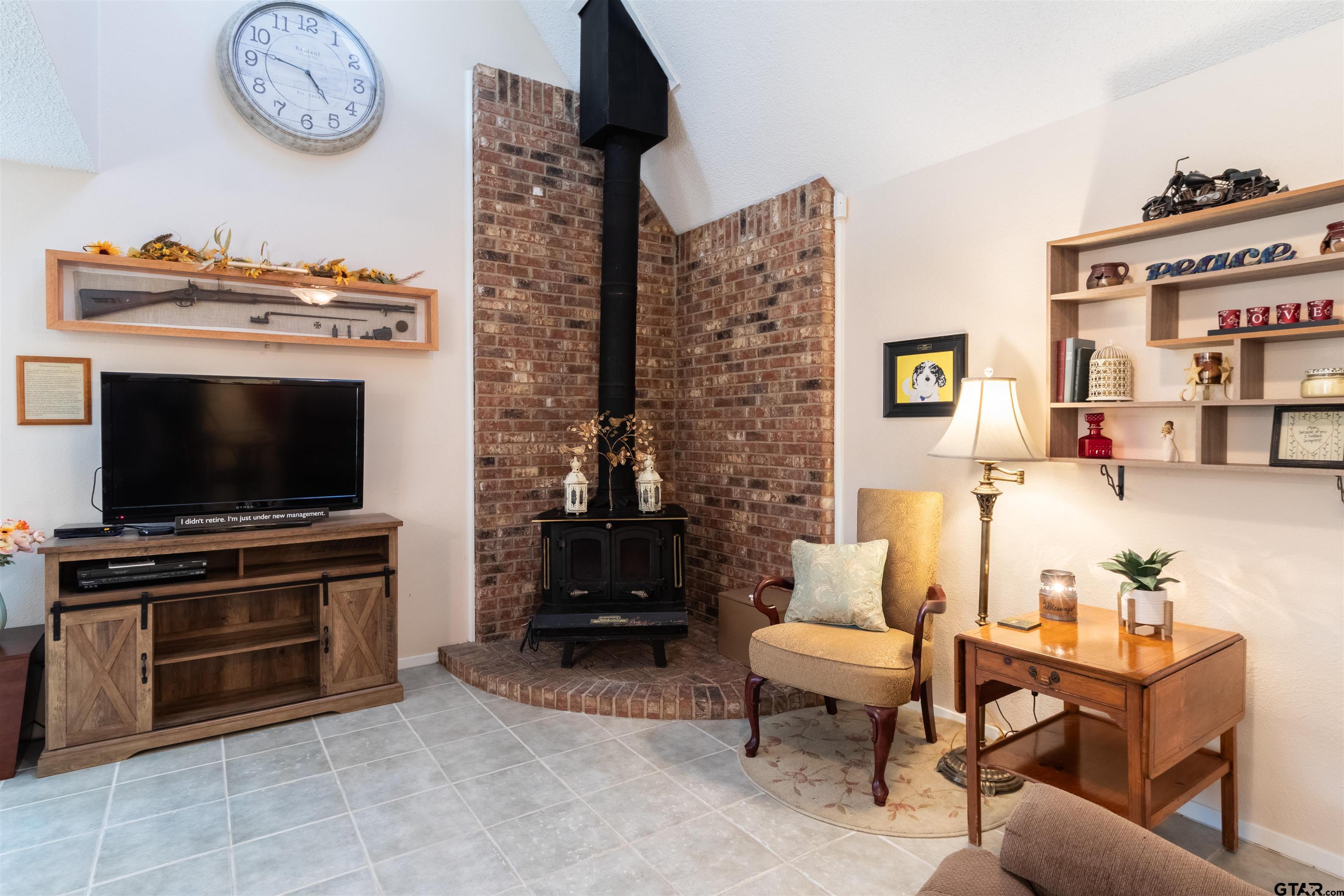 18219 Eastside Road Troup, TX 75789 - Photo 15 of 48 a living room with furniture a flat screen tv and a fireplace