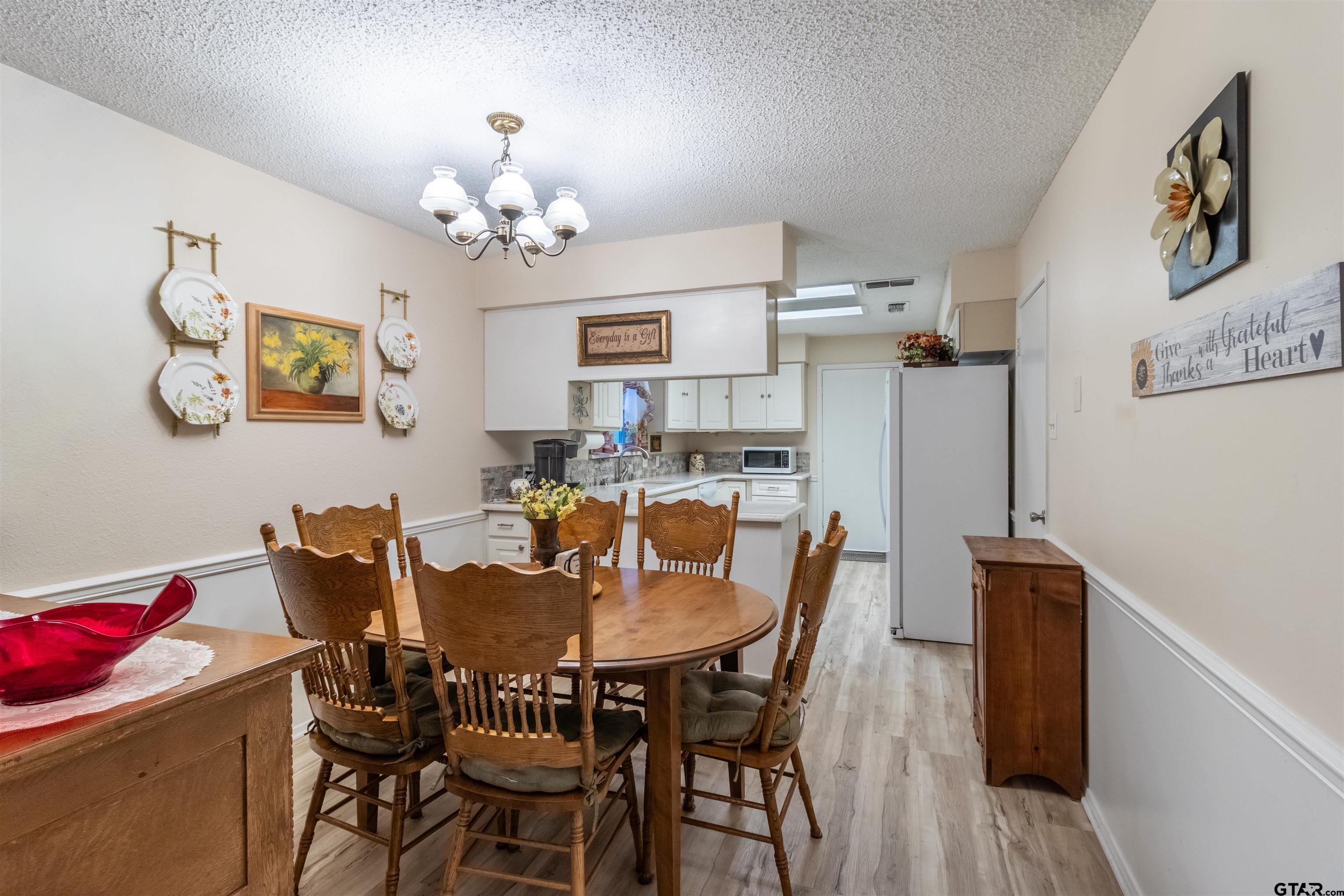 18219 Eastside Road Troup, TX 75789 - Photo 16 of 48 a view of a dining room with furniture and chandelier