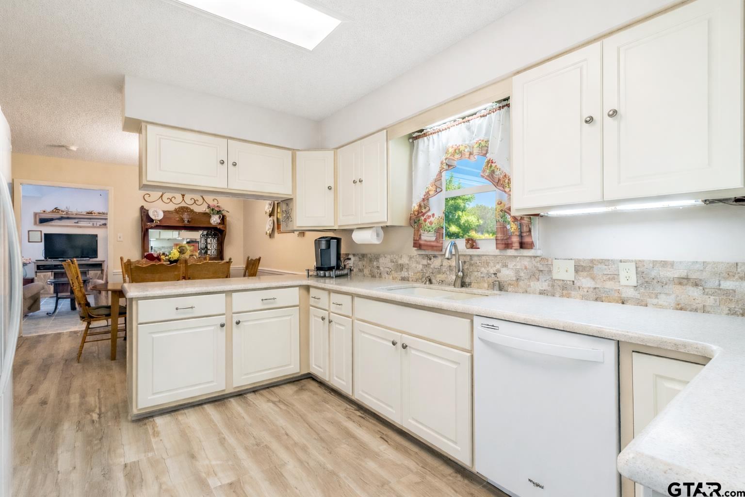 18219 Eastside Road Troup, TX 75789 - Photo 22 of 48 a kitchen with granite countertop white cabinets and white appliances