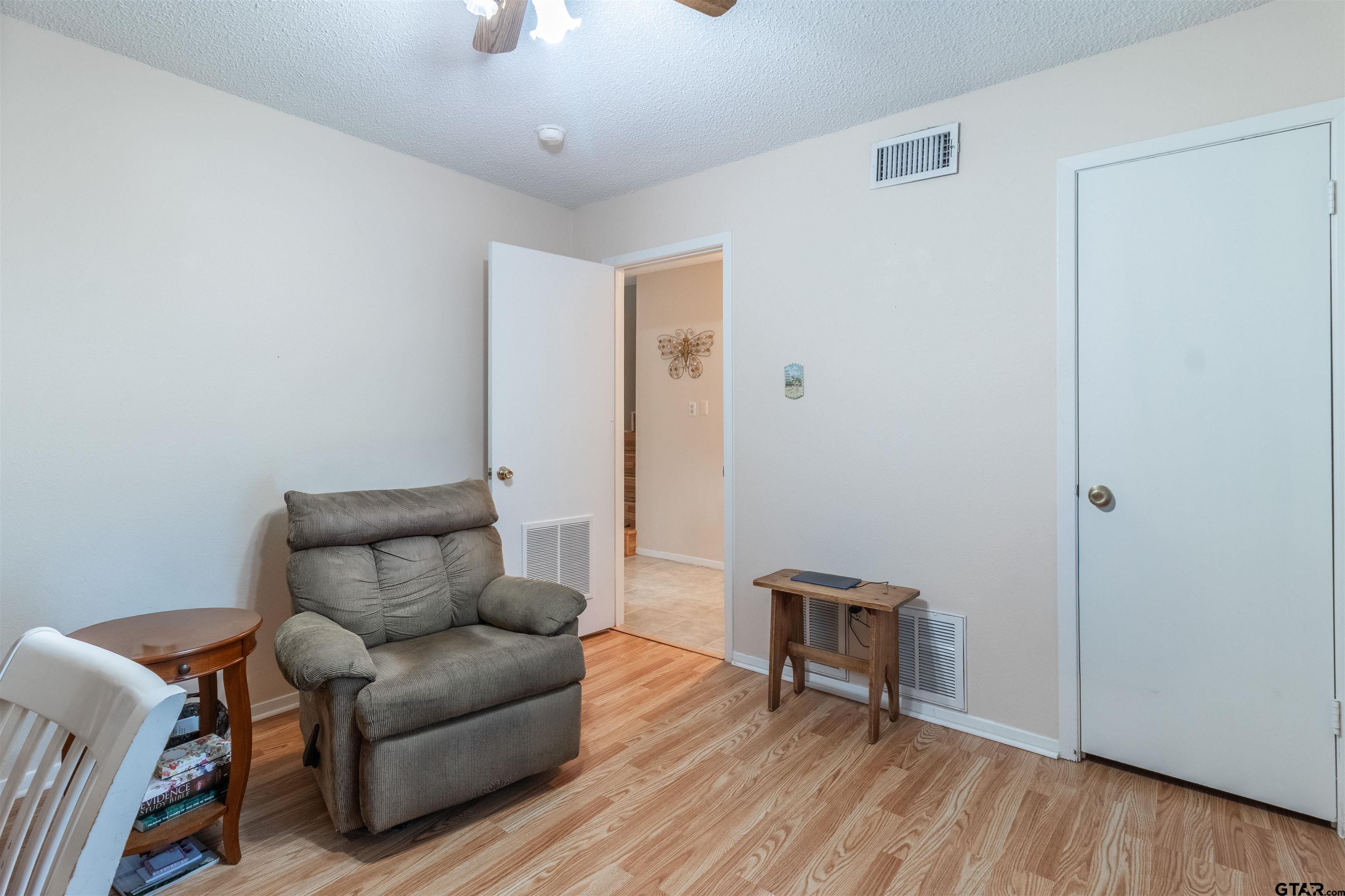 18219 Eastside Road Troup, TX 75789 - Photo 24 of 48 a living room with furniture and a wooden floor