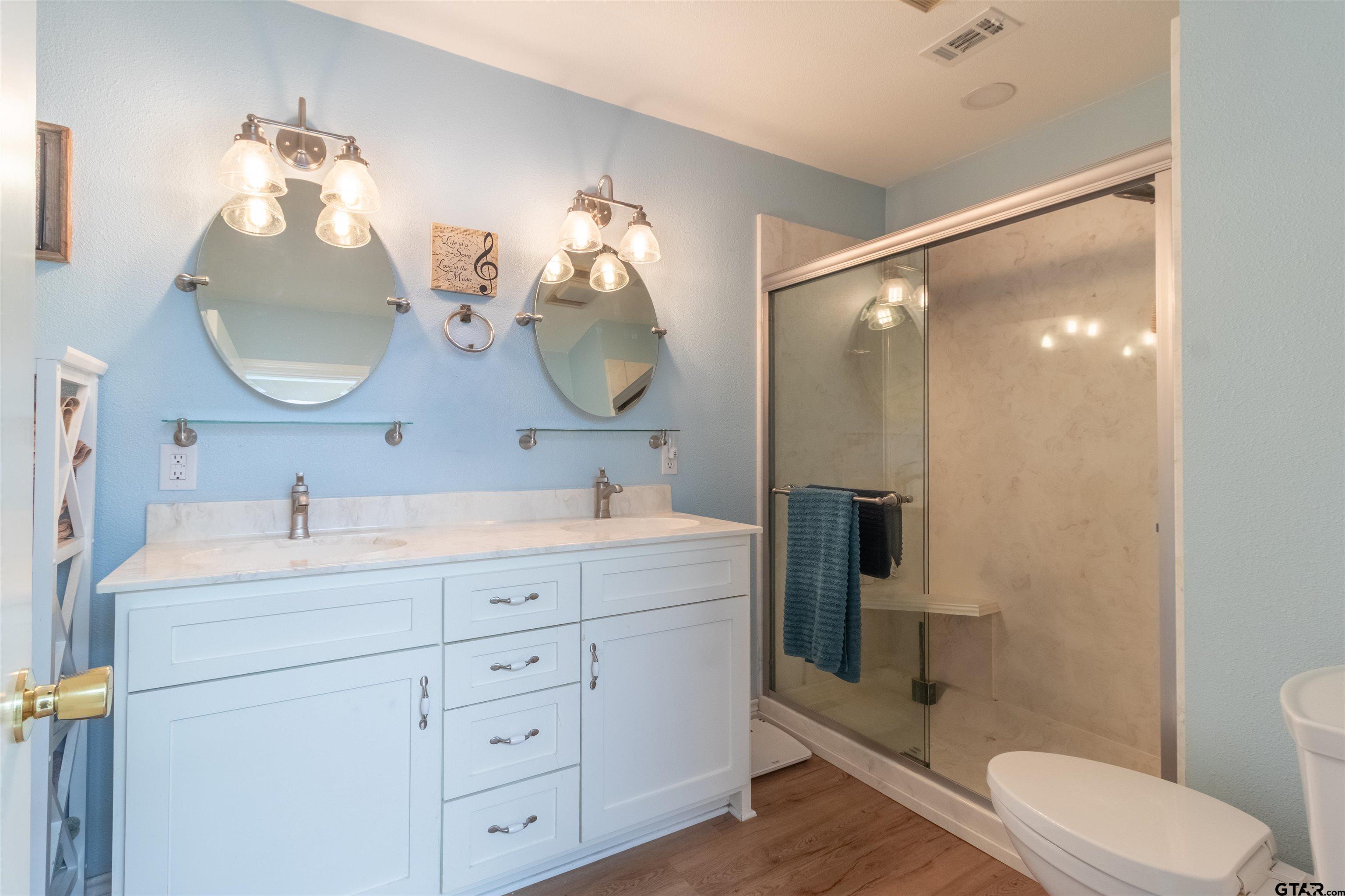 18219 Eastside Road Troup, TX 75789 - Photo 25 of 48 a bathroom with a double vanity sink mirror and toilet