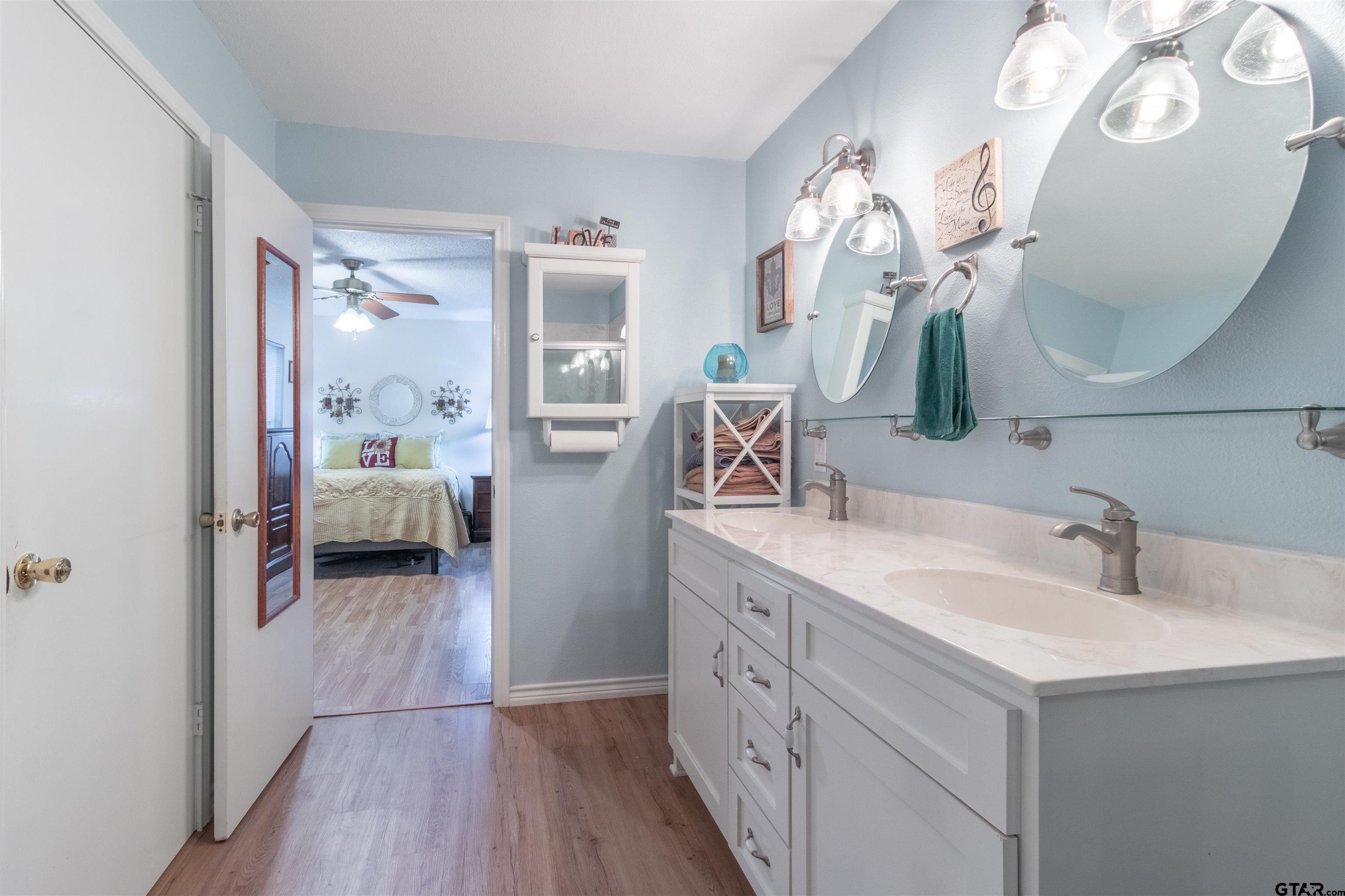 18219 Eastside Road Troup, TX 75789 - Photo 26 of 48 a en suite spacious bathroom with a double vanity sink and a mirror