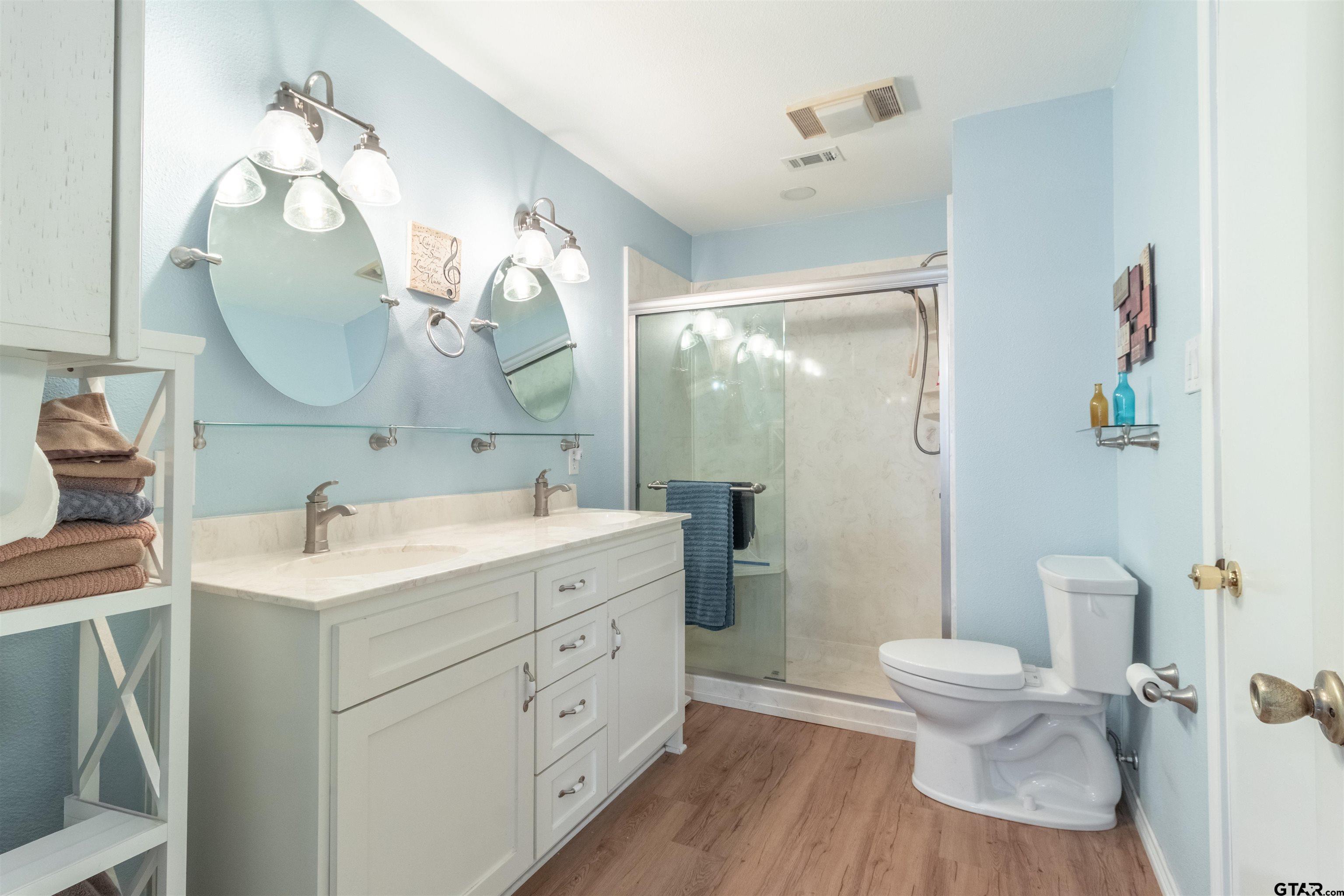 18219 Eastside Road Troup, TX 75789 - Photo 27 of 48 a bathroom with a toilet sink and mirror
