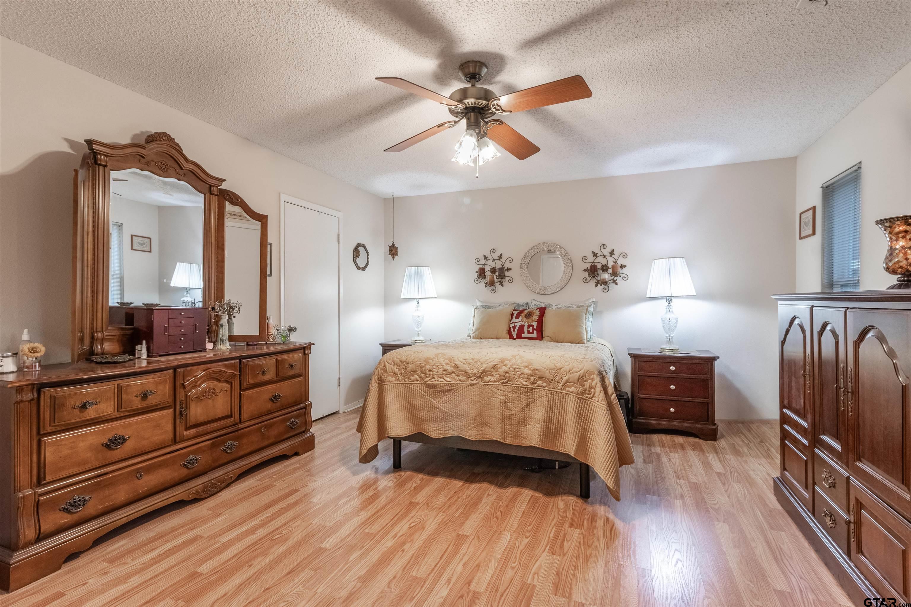 18219 Eastside Road Troup, TX 75789 - Photo 28 of 48 a bedroom with a bed and wooden floor