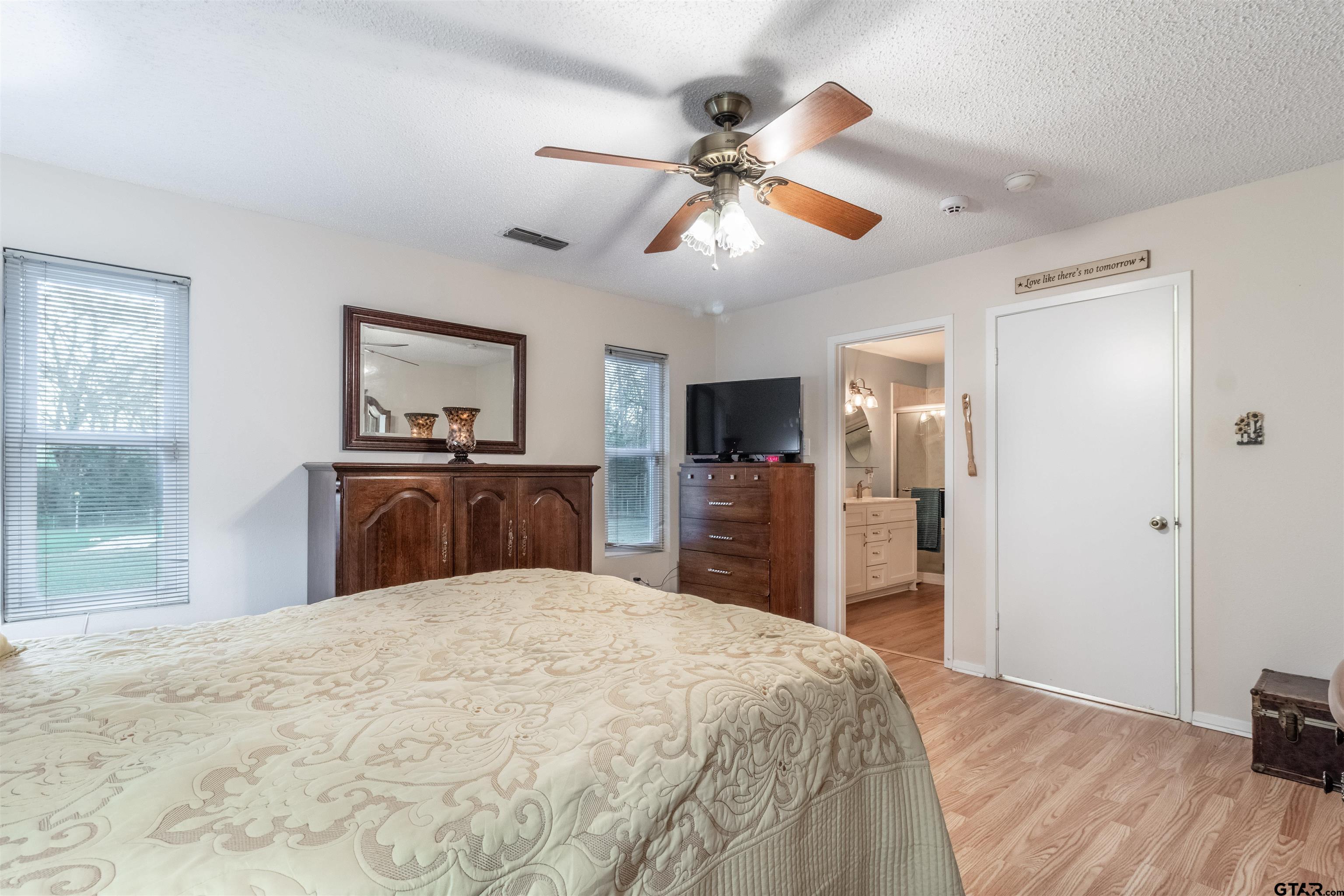 18219 Eastside Road Troup, TX 75789 - Photo 29 of 48 a bedroom with a large bed and a flat tv screen