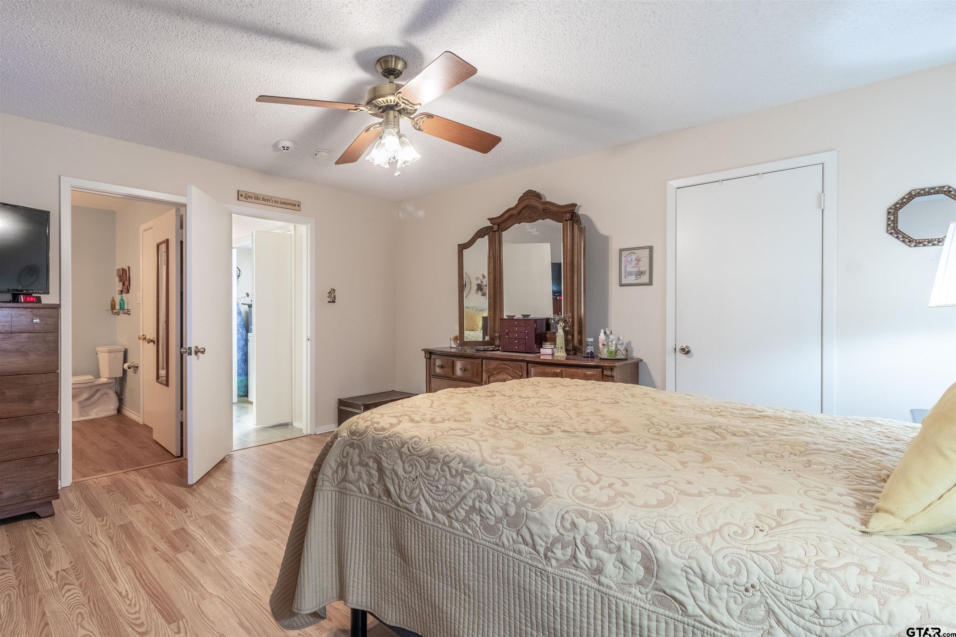 18219 Eastside Road Troup, TX 75789 - Photo 30 of 48 a bedroom with a bed and a chandelier
