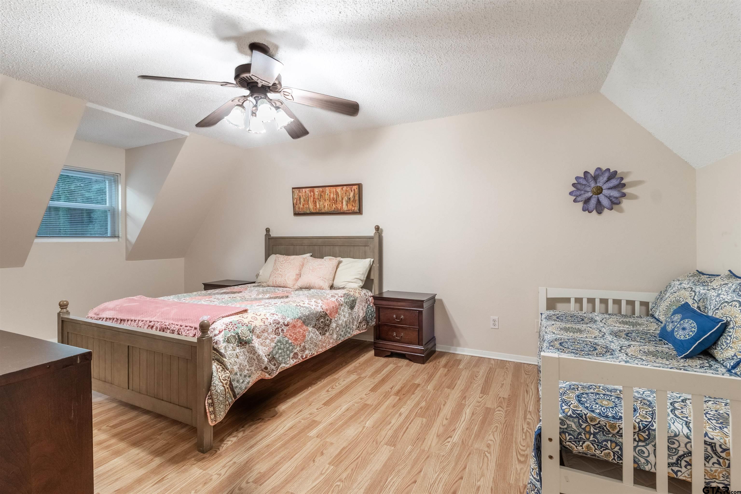 18219 Eastside Road Troup, TX 75789 - Photo 33 of 48 a bedroom with a bed and a chandelier