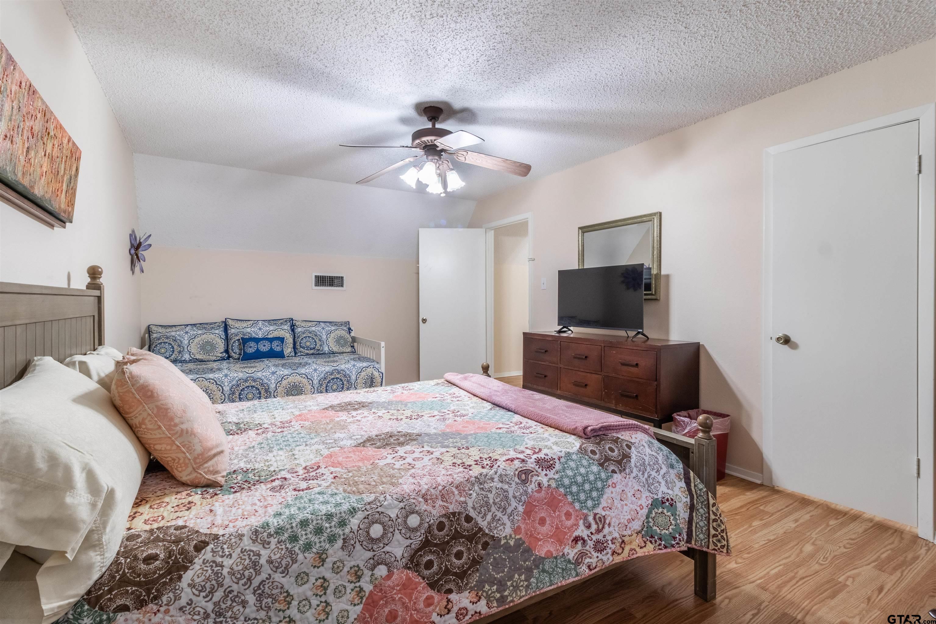 18219 Eastside Road Troup, TX 75789 - Photo 34 of 48 a bedroom with a bed and a flat screen tv