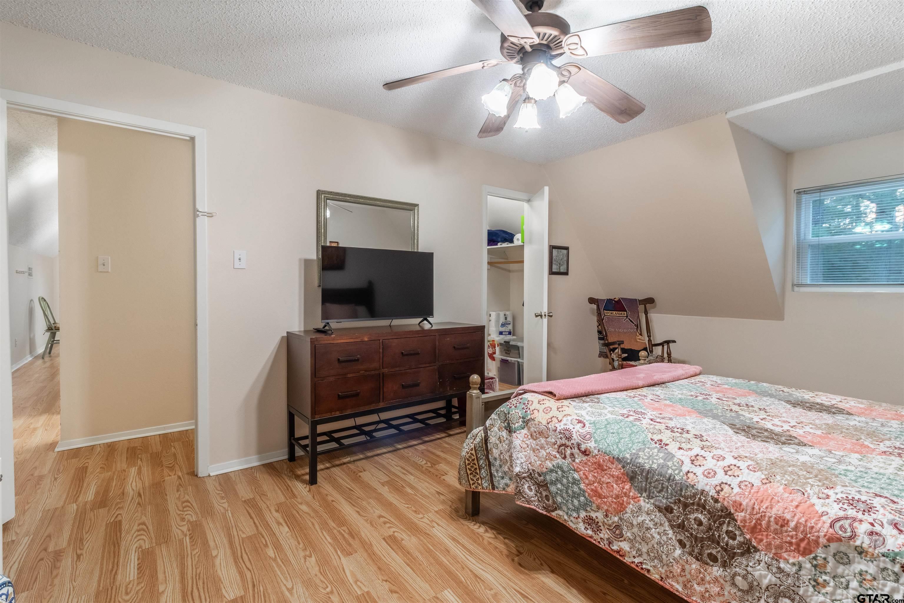 18219 Eastside Road Troup, TX 75789 - Photo 35 of 48 a bedroom with a bed and a flat tv screen on dresser