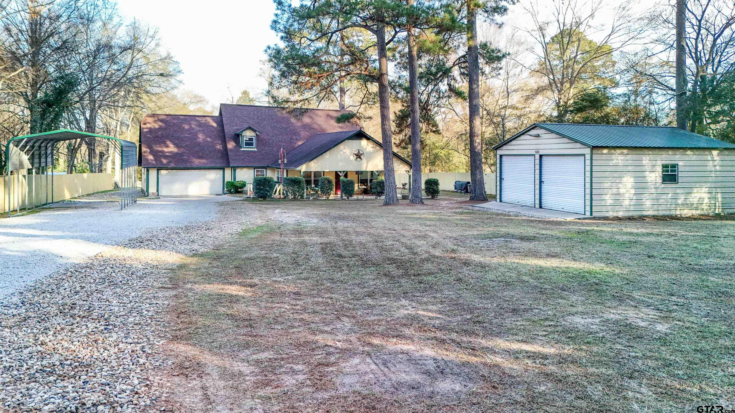 18219 Eastside Road Troup, TX 75789 - Photo 4 of 48 a front view of a house with a yard and garage