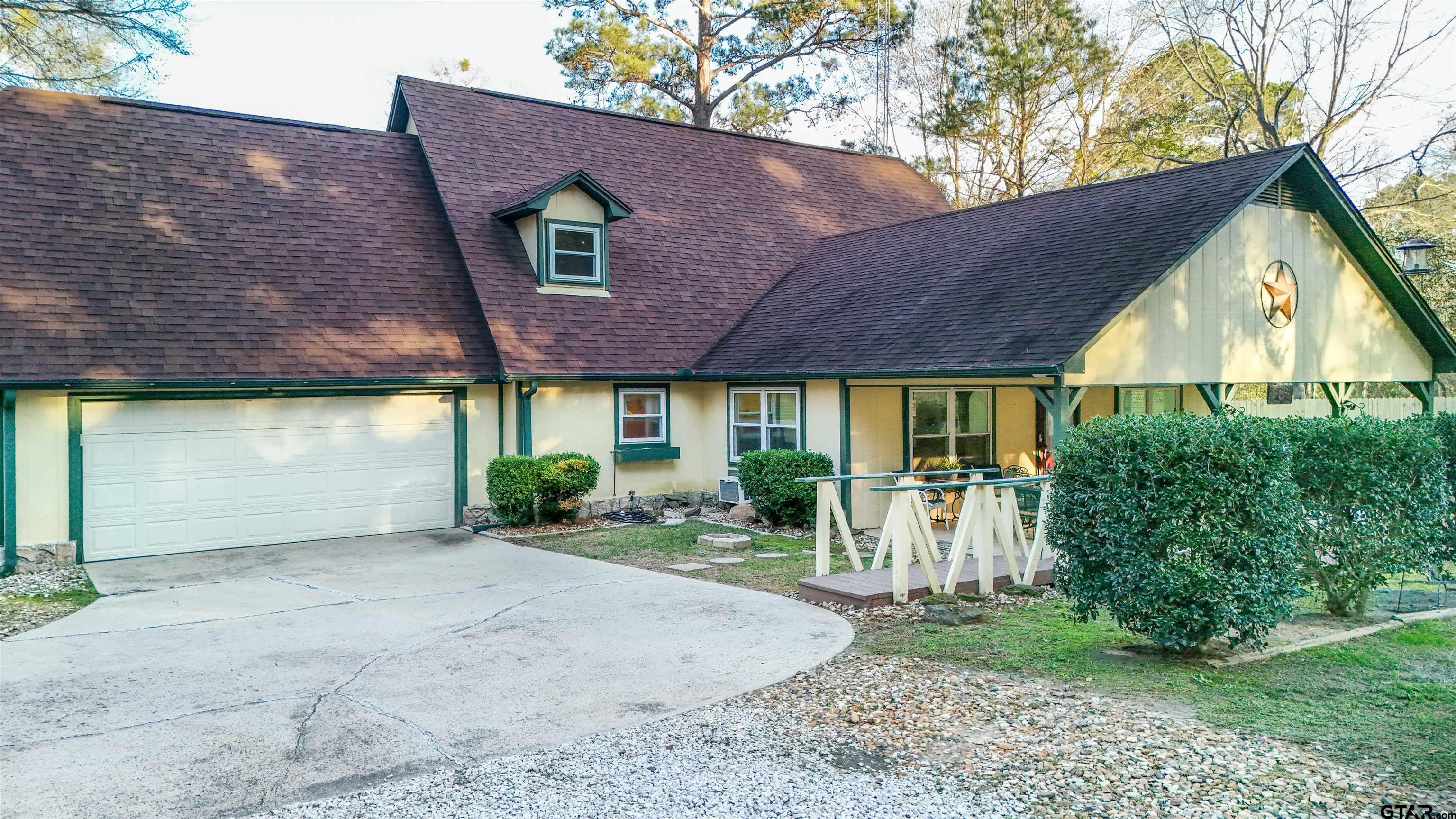 18219 Eastside Road Troup, TX 75789 - Photo 6 of 48 a front view of a house with a yard and potted plants