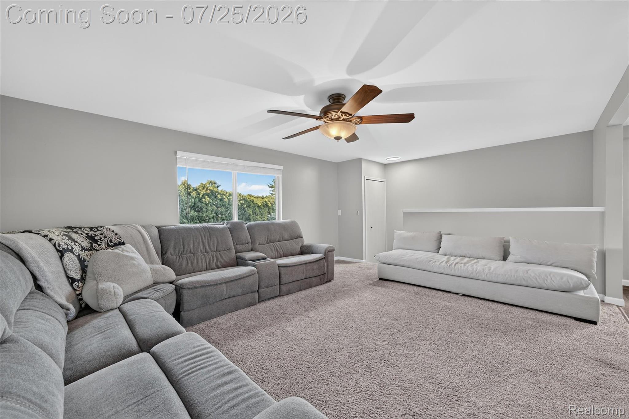 51116 South Foster Road New Baltimore, MI 48047 - Photo 8 of 31 Spacious interior room featuring light gray walls, plush carpeting, and a modern ceiling fan with integrated lighting