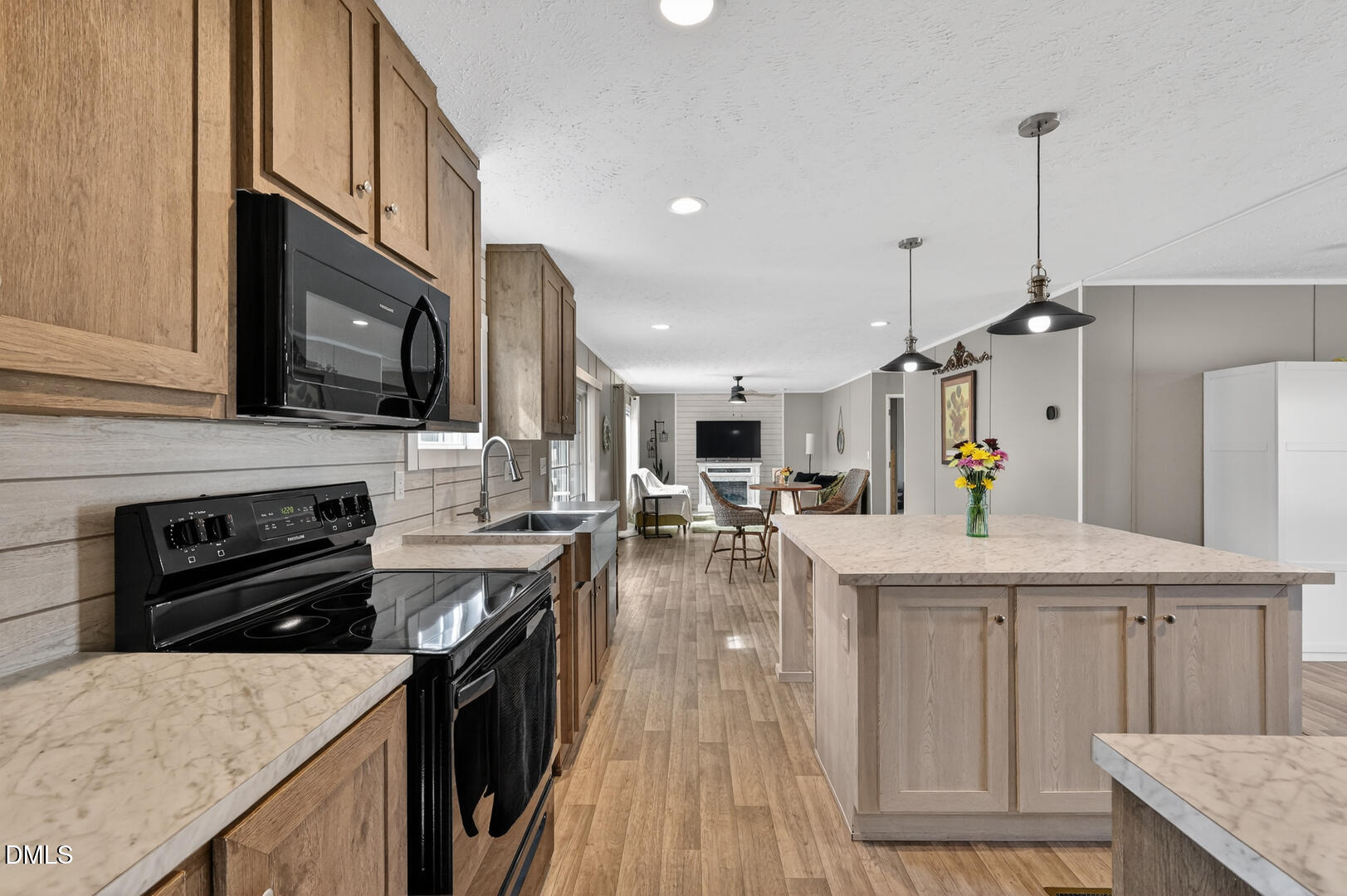 540 Pine Ridge Road Zebulon, NC 27597 - Photo 73 of 96 a kitchen with stainless steel appliances granite countertop a sink stove and refrigerator
