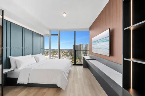 a room with a bed and a large window