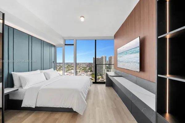 a room with a bed and a large window
