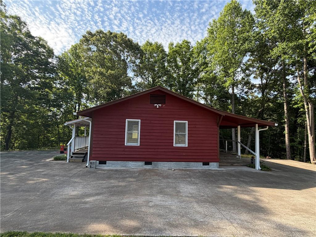86 Robert Jones Road Dawsonville, GA 30534 - Photo 1 of 19 a view of a house and a yard