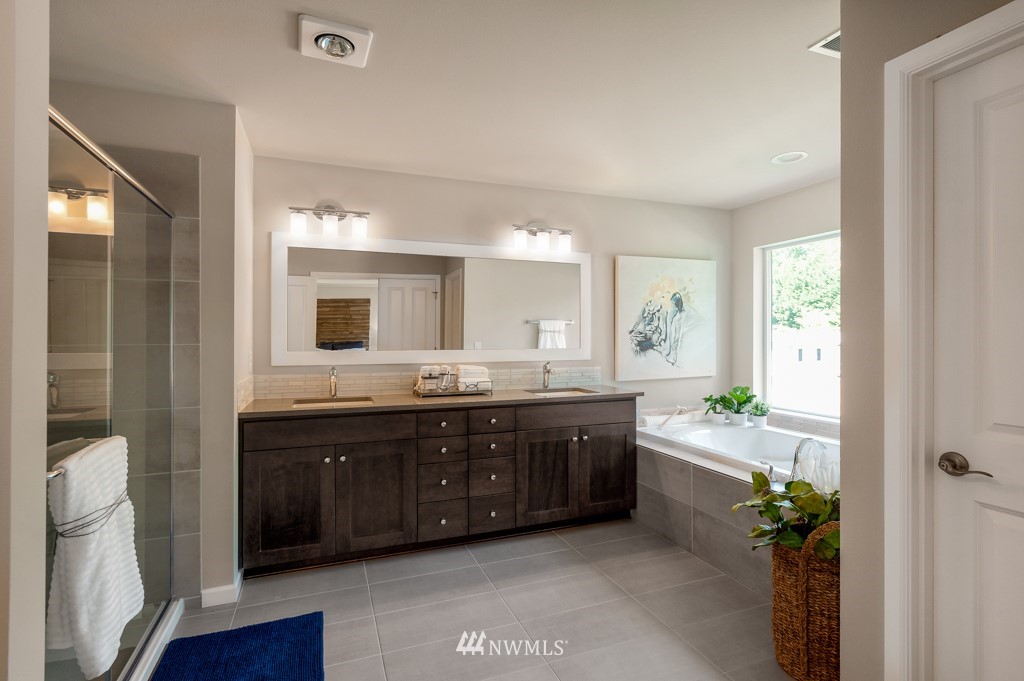 6328 Southeast 5th Place, Unit 5 Renton, WA 98059 - Photo 22 of 25 a spacious bathroom with a granite countertop tub double and mirror