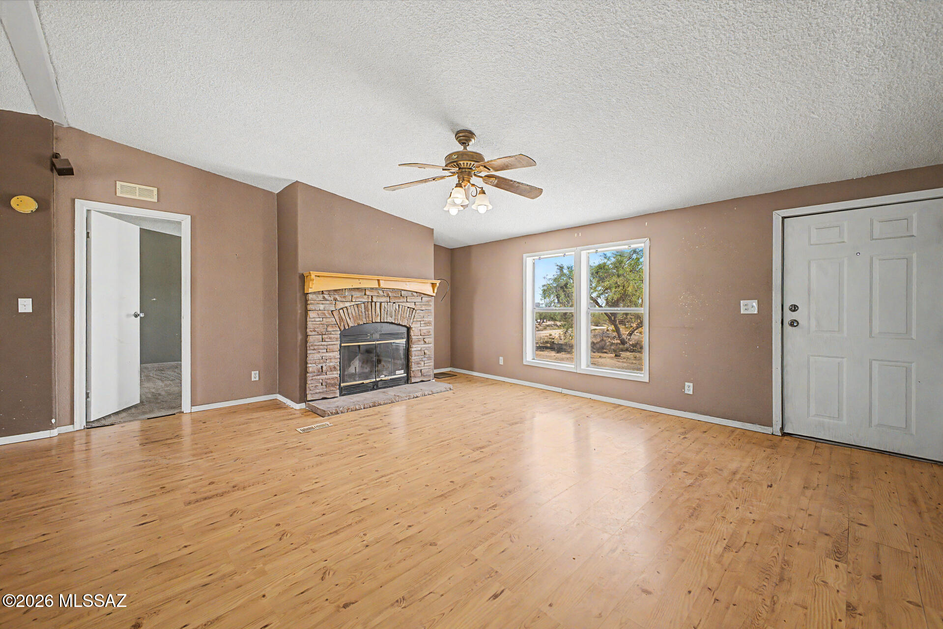 1911 West Thunder Road Vail, AZ 85641 - Photo 4 of 38 a view of an empty room with a window and a kitchen