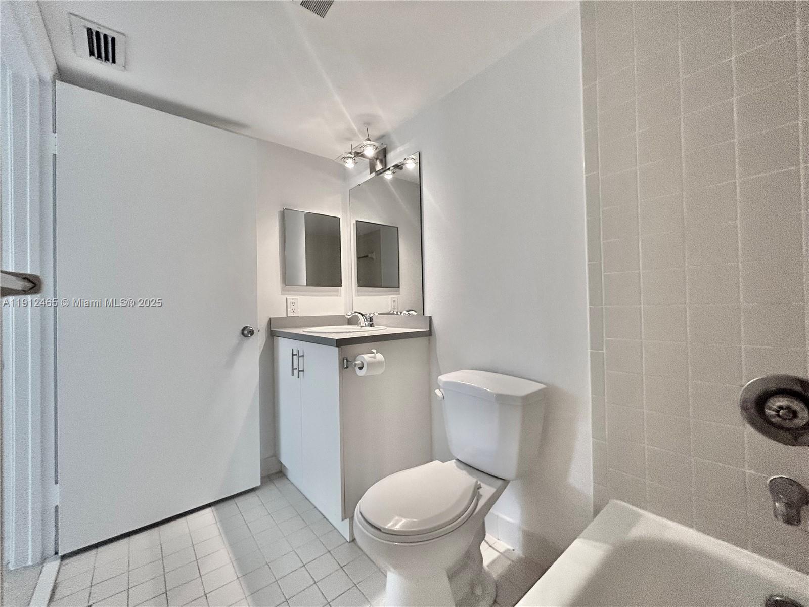 540 South Park Road, Unit 229 Hollywood, FL 33021 - Photo 14 of 44 a bathroom with a toilet a sink and mirror
