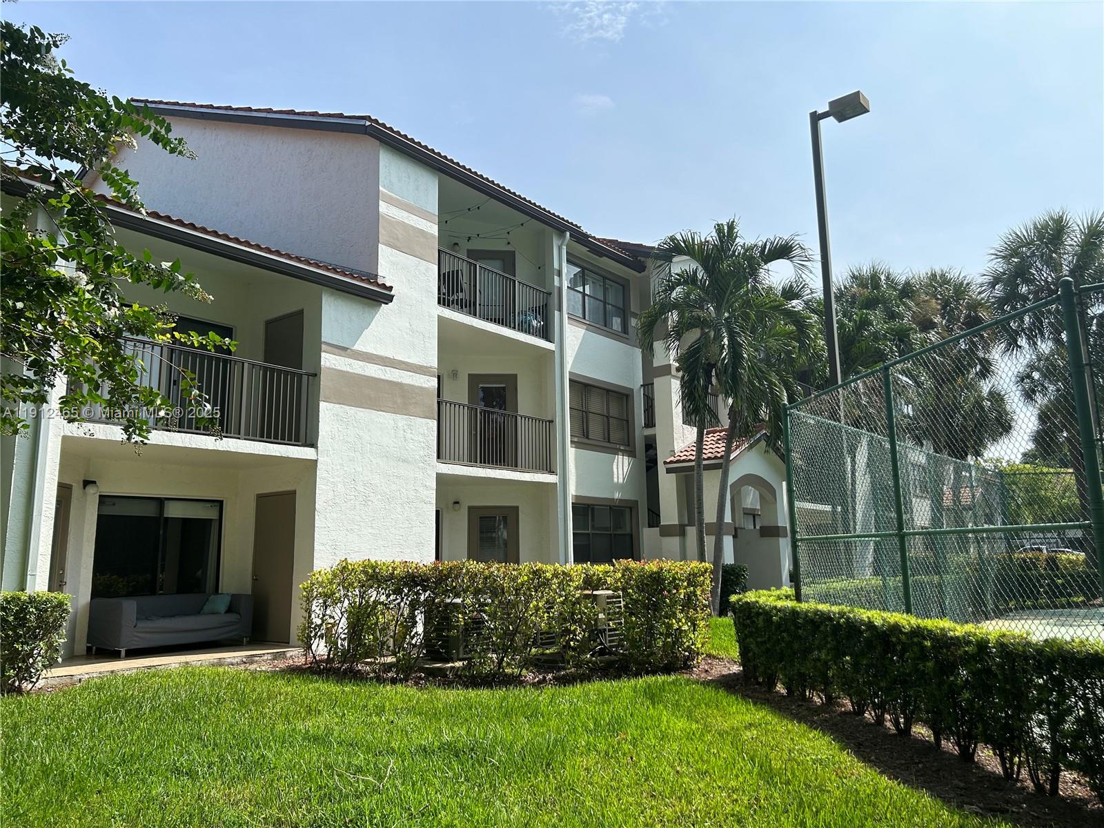540 South Park Road, Unit 229 Hollywood, FL 33021 - Photo 28 of 44 a front view of a house with a garden and plants