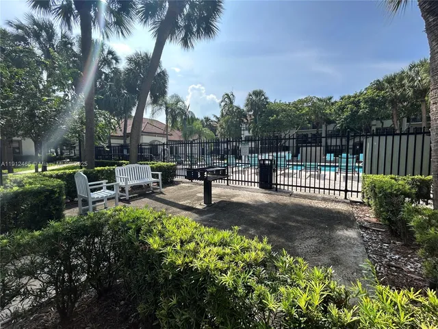 a view of a park with iron fence