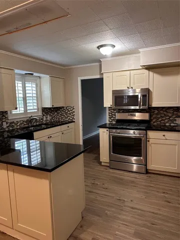 a view of a kitchen with a sink cabinets and a window