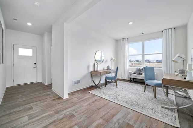 a view of a dining room with furniture window and wooden floor