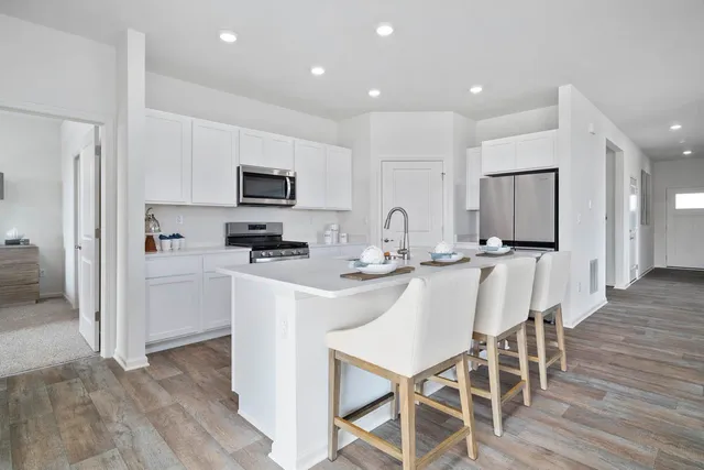 a view of a kitchen with a sink and a stove top oven