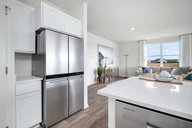 a kitchen with a table chairs a stove a microwave and cabinets