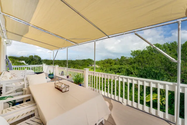 a view of a balcony with yard