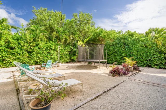 a view of a patio with couches table and chairs and potted plants