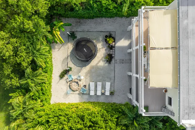 an aerial view of a house with garden space and street view