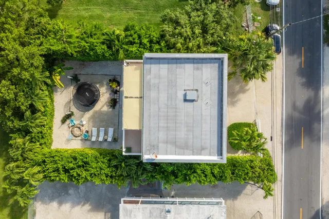 an aerial view of a house with yard swimming pool and outdoor seating