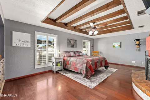 a bed sitting in a spacious bedroom next to a window