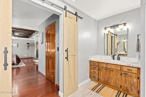 a bathroom with a sink a toilet and a large mirror
