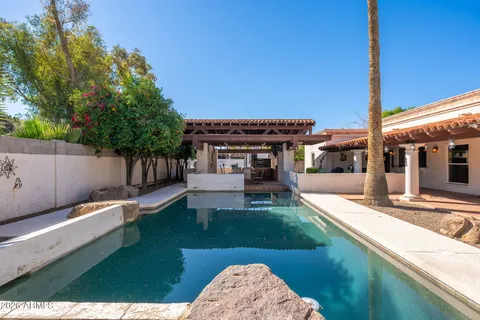 a view of a house with a yard and furniture