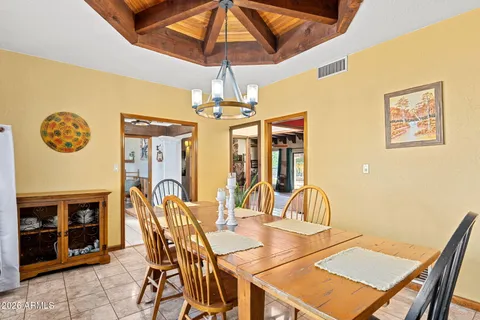 a view of a dining room with furniture and chandelier