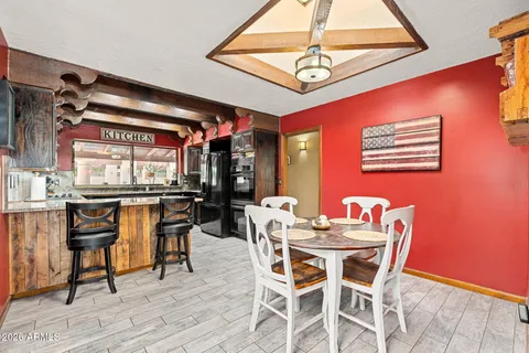 a view of a dining room with furniture and chandelier