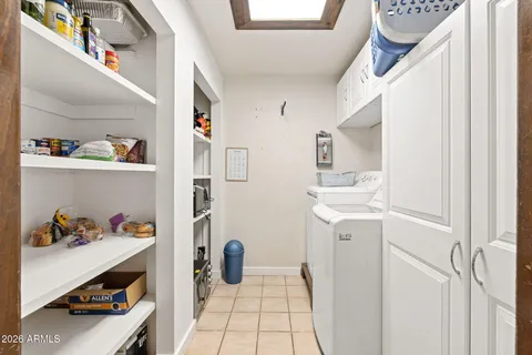 a utility room with a sink dryer and washer