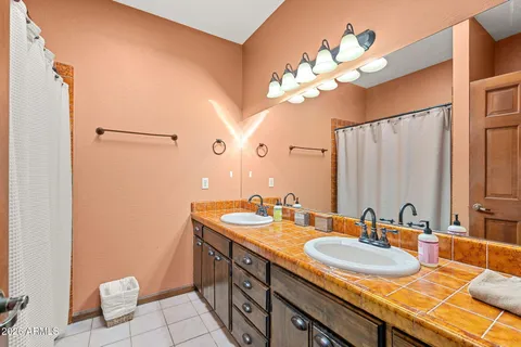 a bathroom with a double vanity sink and a mirror
