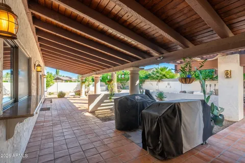 a view of a patio with table and chairs couches with wooden floor and fence