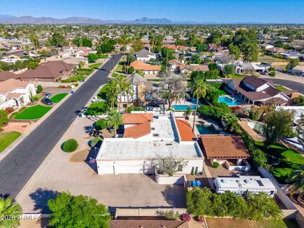 an aerial view of residential houses with outdoor space and parking