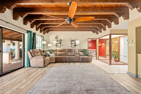 a living room with furniture and a chandelier