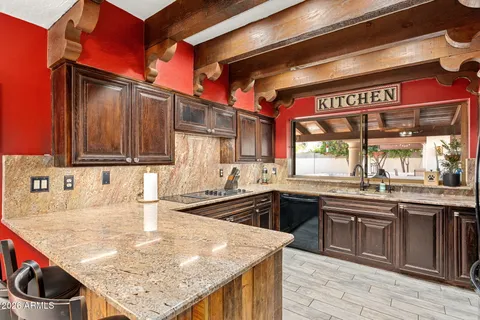 a kitchen with a sink a stove and cabinets