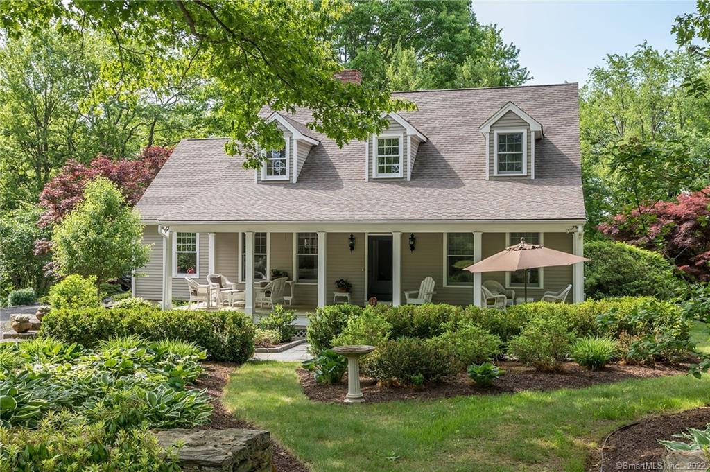 256 Painter Hill Road Roxbury, CT 06783 - Photo 1 of 1 a front view of a house with a yard and trees