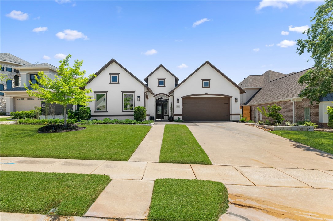 2833 Persimmon Ridge Court Bryan, TX 77807 - Photo 10 of 50 a front view of a house with a yard and garage