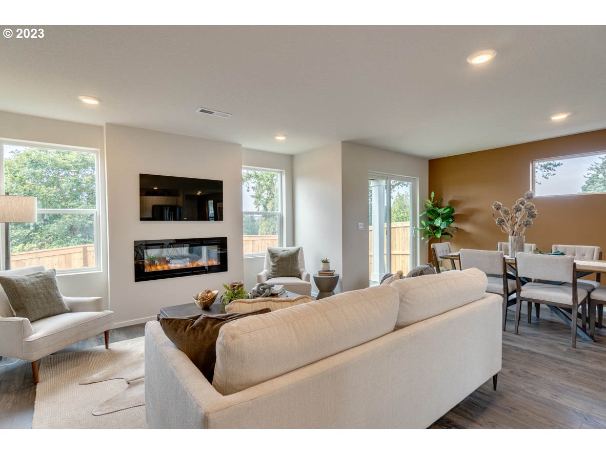 2932 North 3rd Way Ridgefield, WA 98642 - Photo 6 of 26 a living room with furniture flat screen tv and a large window