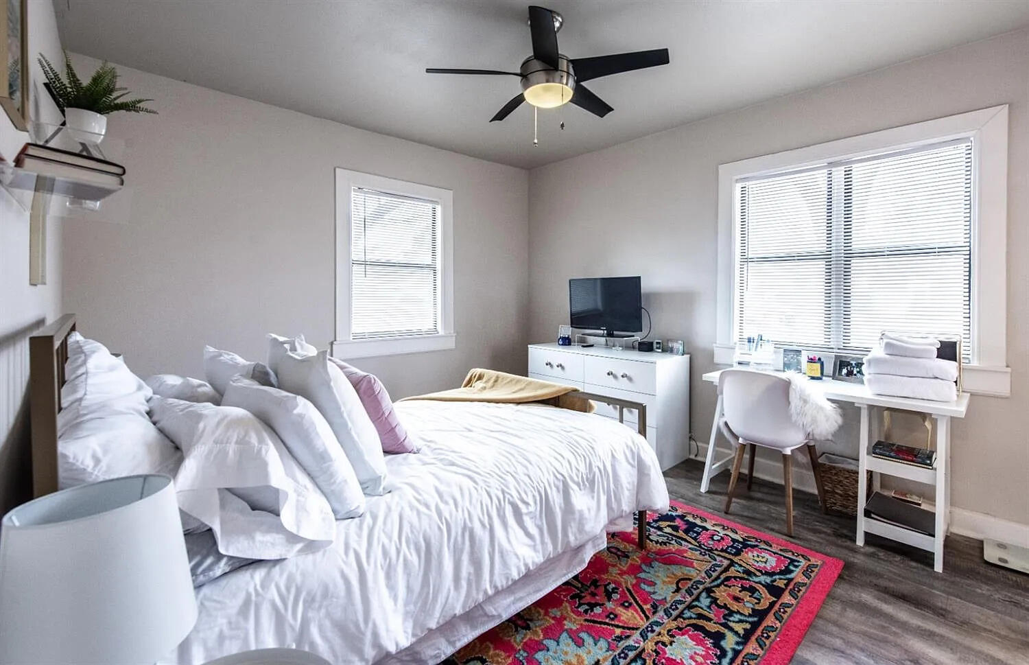 3105 29th Street Lubbock, TX 79410 - Photo 6 of 18 a bed room with a bed tv and a window