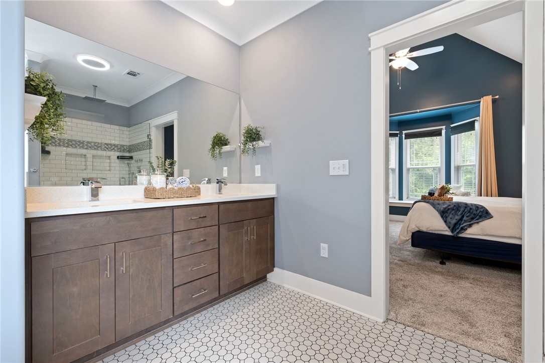 1050 Old Dacusville Road Easley, SC 29640 - Photo 19 of 33 This bathroom offers a large double vanity and a shower with tiled walls.